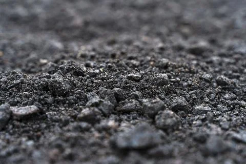 Black soil texture background. Black land surface. Farm agriculture field. Stock Photos