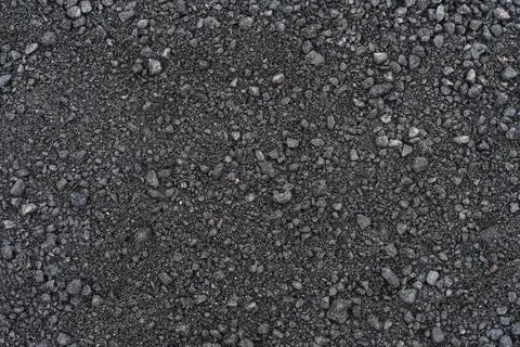 Black soil texture background. Black land surface. Farm agriculture field. Stock Photos