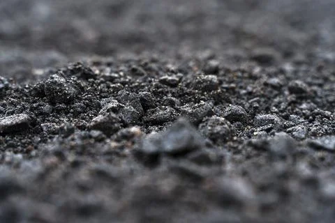 Black soil texture background. Black land surface. Farm agriculture field. Stock Photos