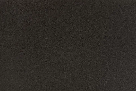 Black solid background. Dark grey grainy background. Stock Photos