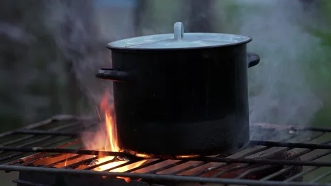 Black sooted pot on the open flame Stock Footage 132998319