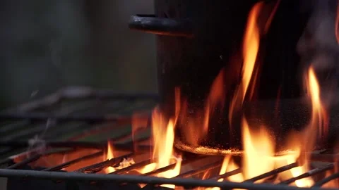 Black sooted pot on the open flame. Close up Stock Footage 132998322