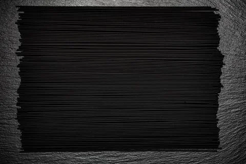Black spaghetti background. Spaghetti squid ink "romagnola" style. Stock Photos