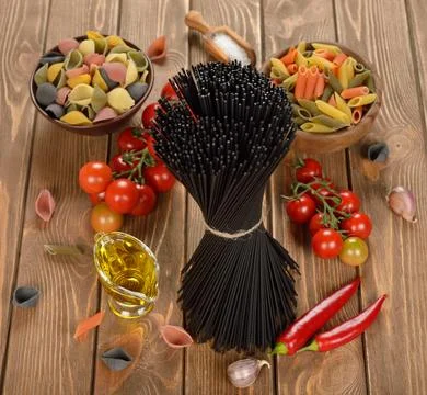 Black spaghetti on a brown background Stock Photos