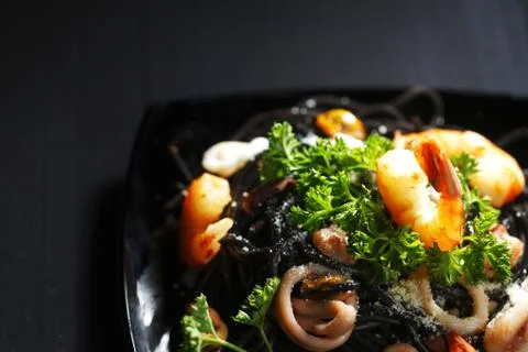 Black spaghetti with seafood Stock Photos