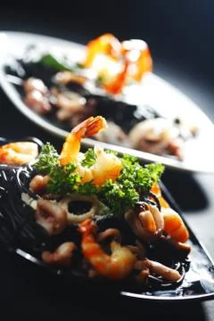Black spaghetti with seafood Stock Photos