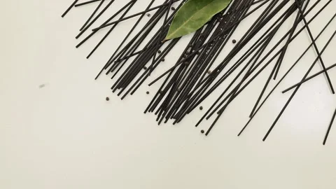Black Spaghetti in white background with black pepper Stock Footage 235550474