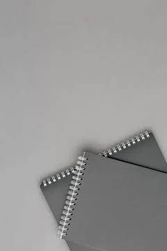 Black spiral notepad on gray background Stock Photos