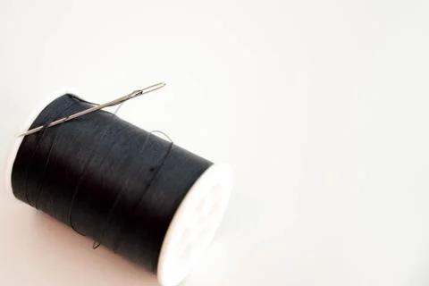 Black spool of thread and needle Stock Photos