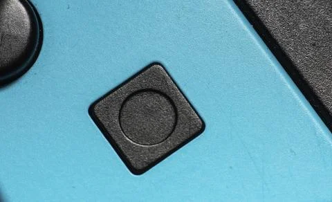A black square button on a blue hand controller Stock Photos