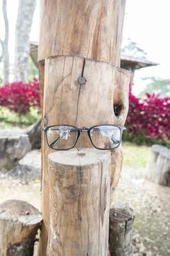 Black square eyeglass frame on old wood. square eyeglass frame in the photo f Stock Photos