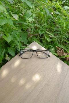 Black square eyeglass frames on old wood. square eyeglass frames in the photo Stock Photos