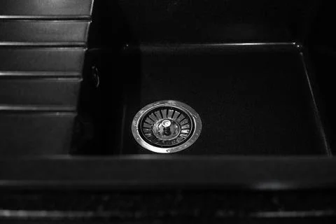 Black square kitchen deep sink with metal drain. Home interior Stock Photos