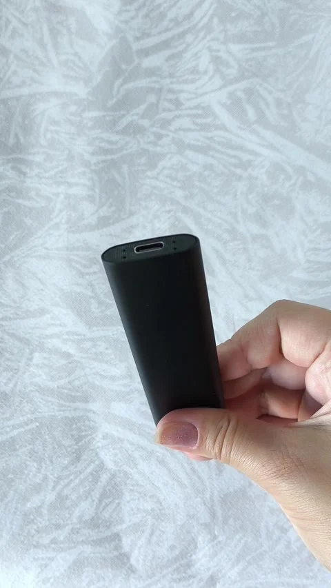 Black ssd external drive for PC, laptop in a womans hand. Flash drive, memory Stock-Footage 313980438
