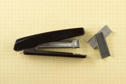 Black stapler with paper clips Stock Photos