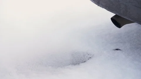 Black steam from tailpipe of cold diesel car on the white snow in winter. 動画素材 101319399