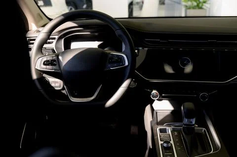 Black steering wheel, automatic transmission,control display in a modern car. Stock Photos