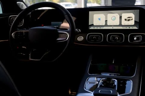 Black steering wheel, automatic transmission,control display in a modern car. Stock Photos