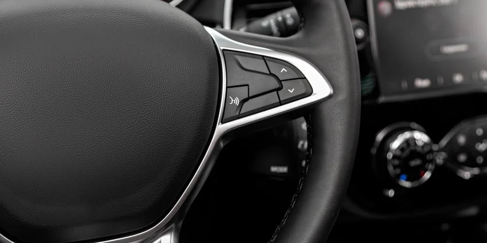 Black steering wheel with multifunction buttons for quick control, close-up i Stock Illustration