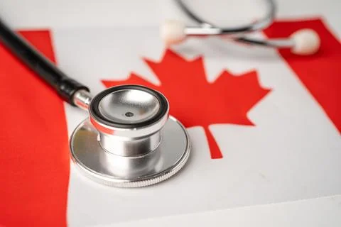 Black stethoscope on Canada flag background, Business and finance concept. Stock Photos