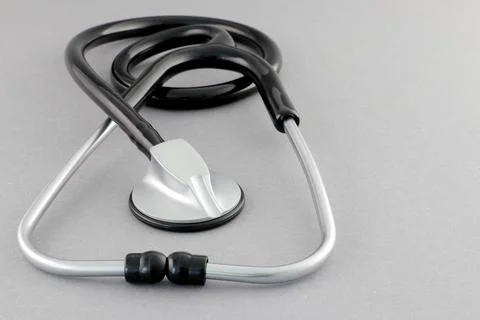 Black stethoscope on a gray background Stock Photos