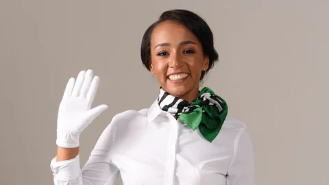 Black stewardess on gray background Stock Footage 97986226