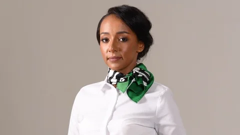 Black stewardess on gray background 스톡 동영상 97986881