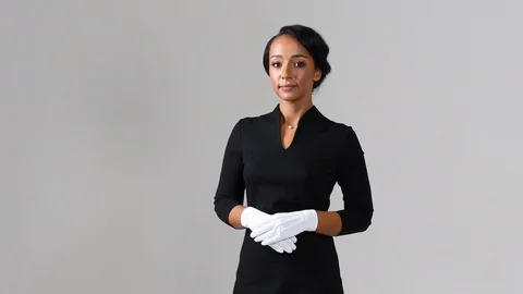 Black stewardess on gray background Stock Footage 98210391