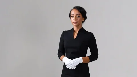 Black stewardess on gray background 스톡 동영상 98210811