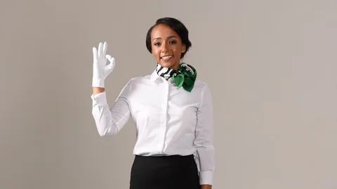 Black stewardess on gray background Stock Footage 98212905