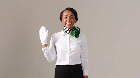 Black stewardess on gray background Stock Footage 98213235