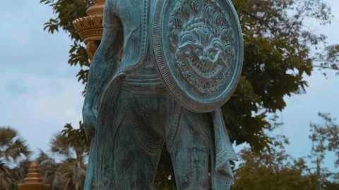 Black stone statue of ancient warrior with bow, swords and shield Stock Footage 318686267