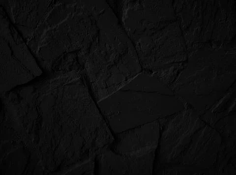 Black stone textured wall. Grunge background Stock Photos