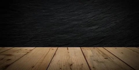 Black stone wall background and wood table Stock Photos