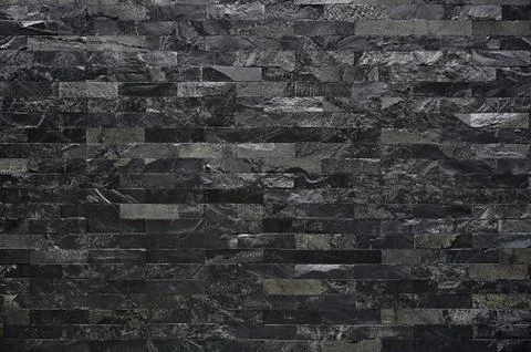 Black stone wall texture background square brick stones used to decorate the Stock Photos