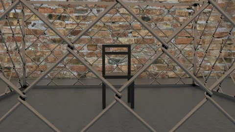 Black stool is inside a metal cage. The cell is placed in a brick chamber. The Stock Footage 128828646