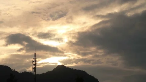 Black stormy cloud on Dramatic colorful Sunset sky n telecommunication tower Stock Footage 157309760