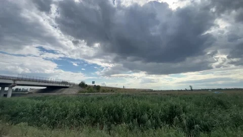 Black stormy clouds on a countryside field panoramic shot Stock Footage 203771553