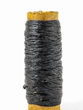 A black string is wrapped around a wooden stick Stock Photos