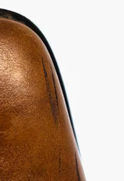 Black stripes on a man's brown boot. White background Stock Photos