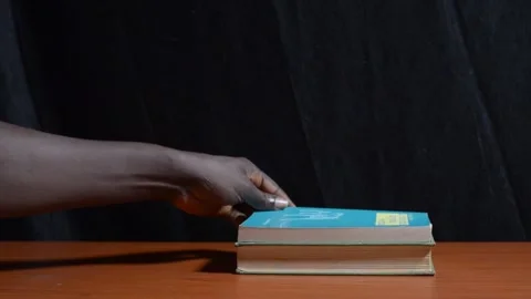 A black student hands stacking books Stock Footage 276594023