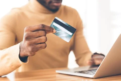 Black student making purchases using laptop computer 스톡 사진