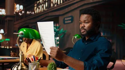 Black student rehearsing lines from the script for drama school course Stock Photos