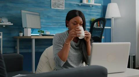 Black student smiling while working at social media blog article typing 스톡 사진