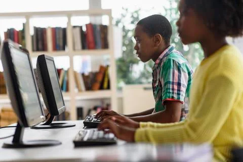 Black students using computers in classroom 스톡 사진