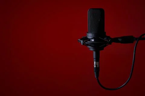 Black studio condenser microphone on red background, Stock Photos