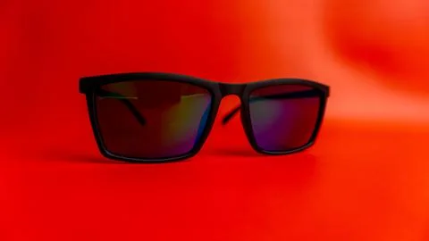 Black sunglasses on red background Stock Photos