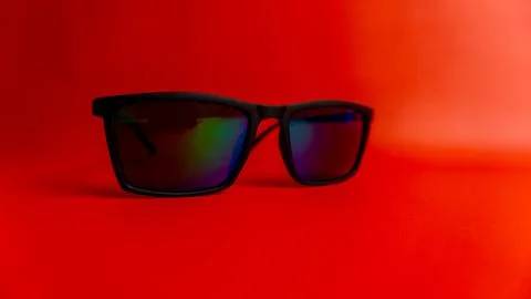 Black sunglasses on red background Stock Photos