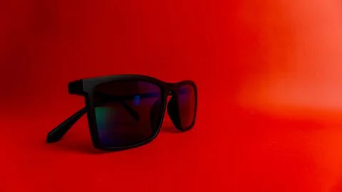 Black sunglasses on red background Stock Photos