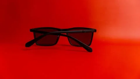 Black sunglasses on red background Stock Photos